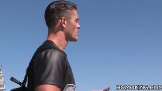 Hot guy picking up and blowing off a muscular man on the bea