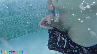 Gay guy cheekily jerks off his fat cock in a public thermal pool. Hot underwater fun.