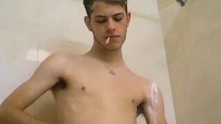 Skinny gay Bleu jerking off while smoking in the shower