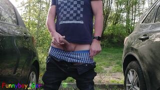 Publicly outside, I jerk my hot cock between cars in a commuter parking lot. But unfortunately cars kept coming by.