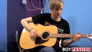 Young man plays guitar before dick stroking and cumming