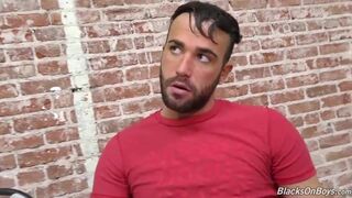 Bearded guy sucking off a black cock at a gloryhole