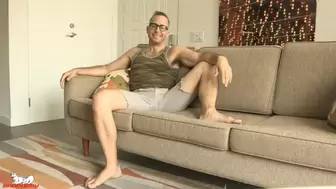 Joel starts jacking his cock as he bends over the sofa