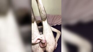 Very hairy skinny blue-eyed white guy jerks off big uncut cock with legs in the air